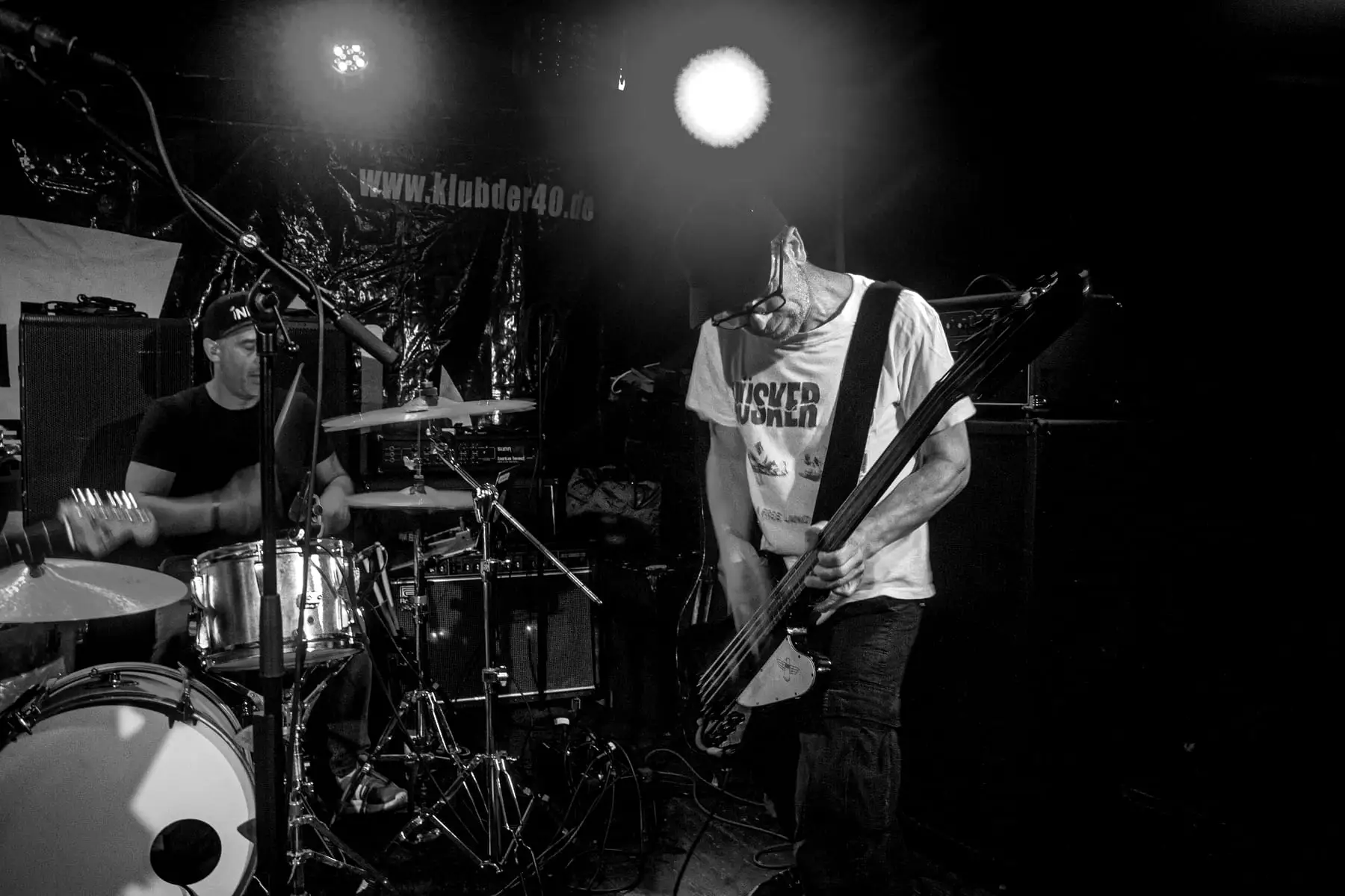 Bassist bent low over his instrument