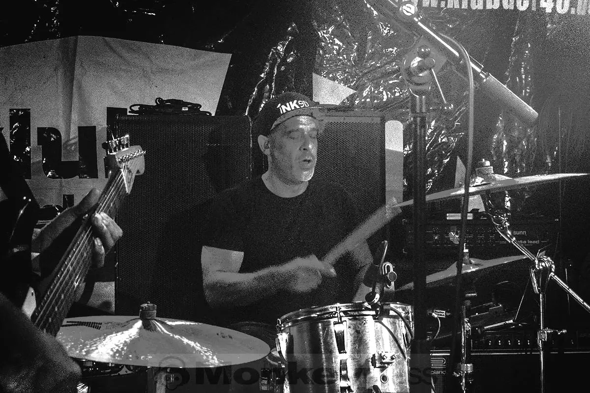 Drummer mid-hit, sticks blurred with motion