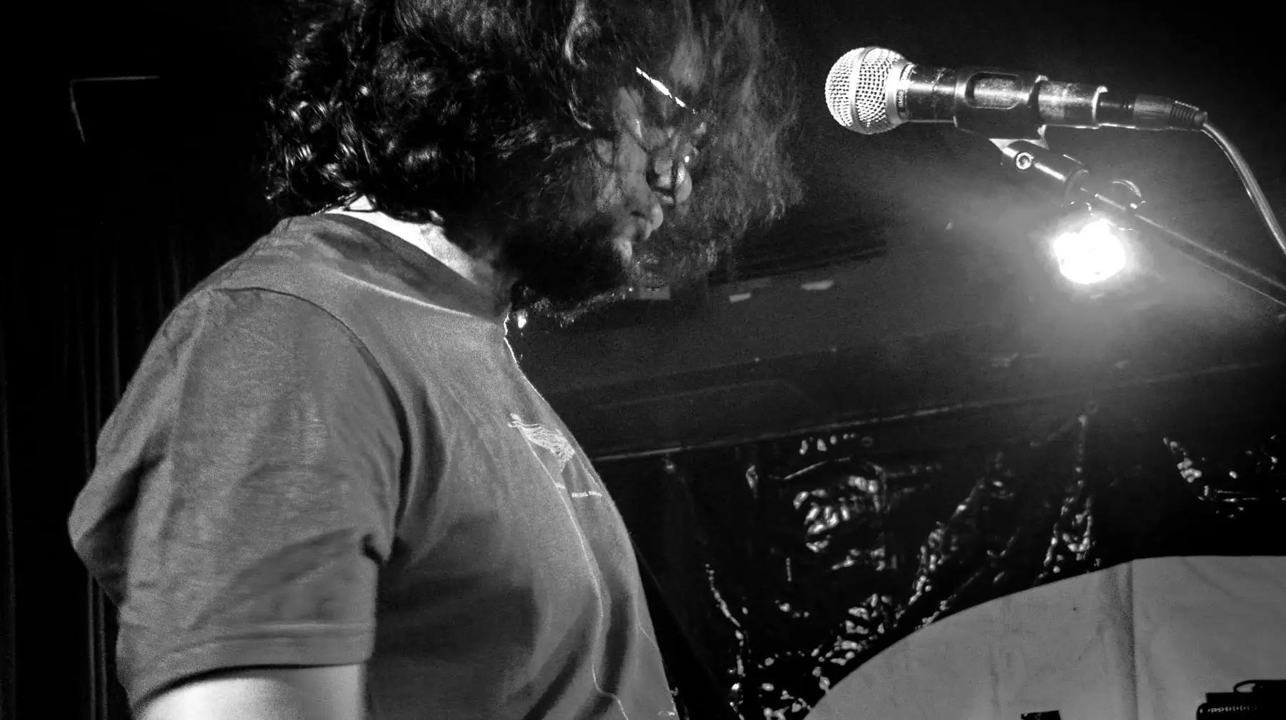 Musician in profile, head bowed between songs