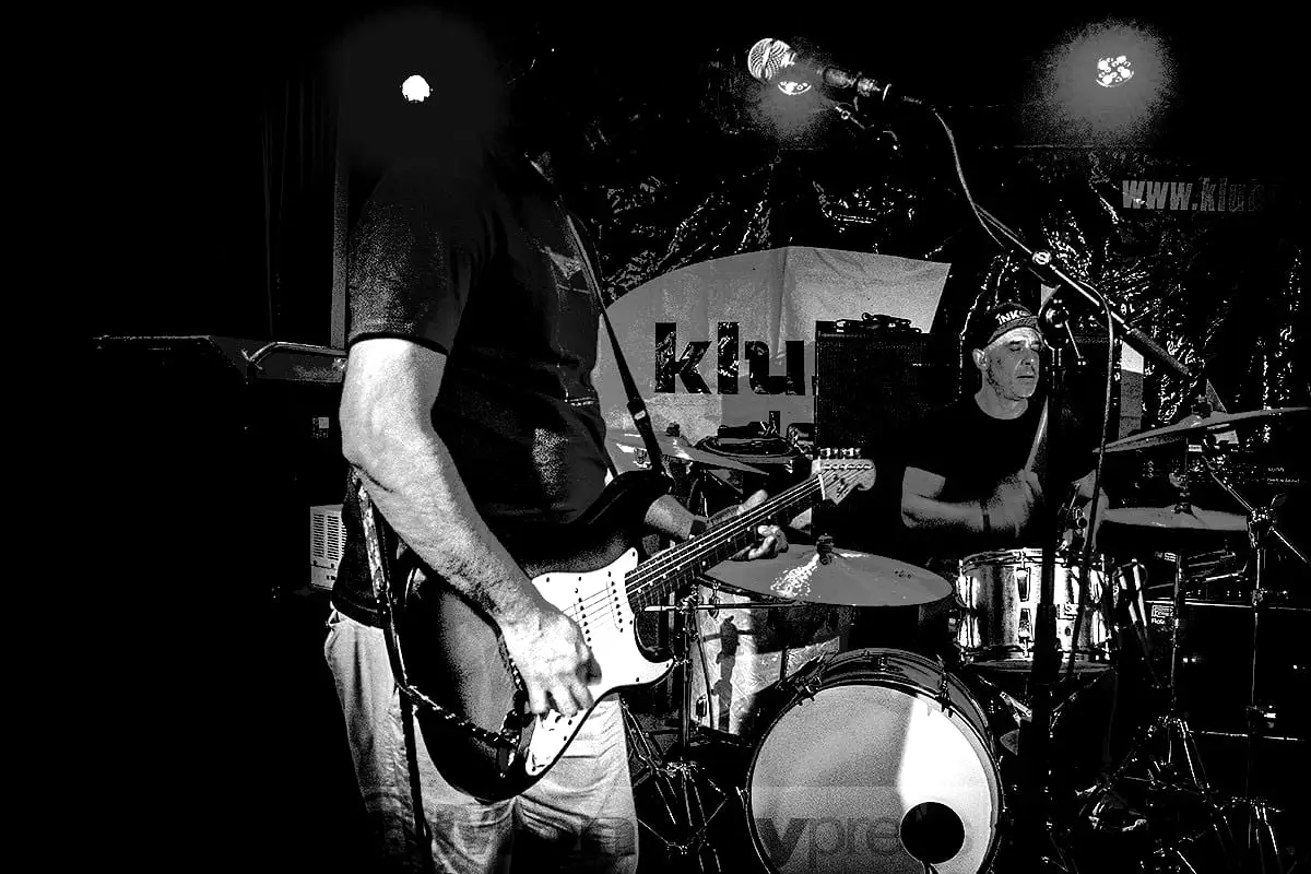 Stratocaster in the foreground, stage lights behind