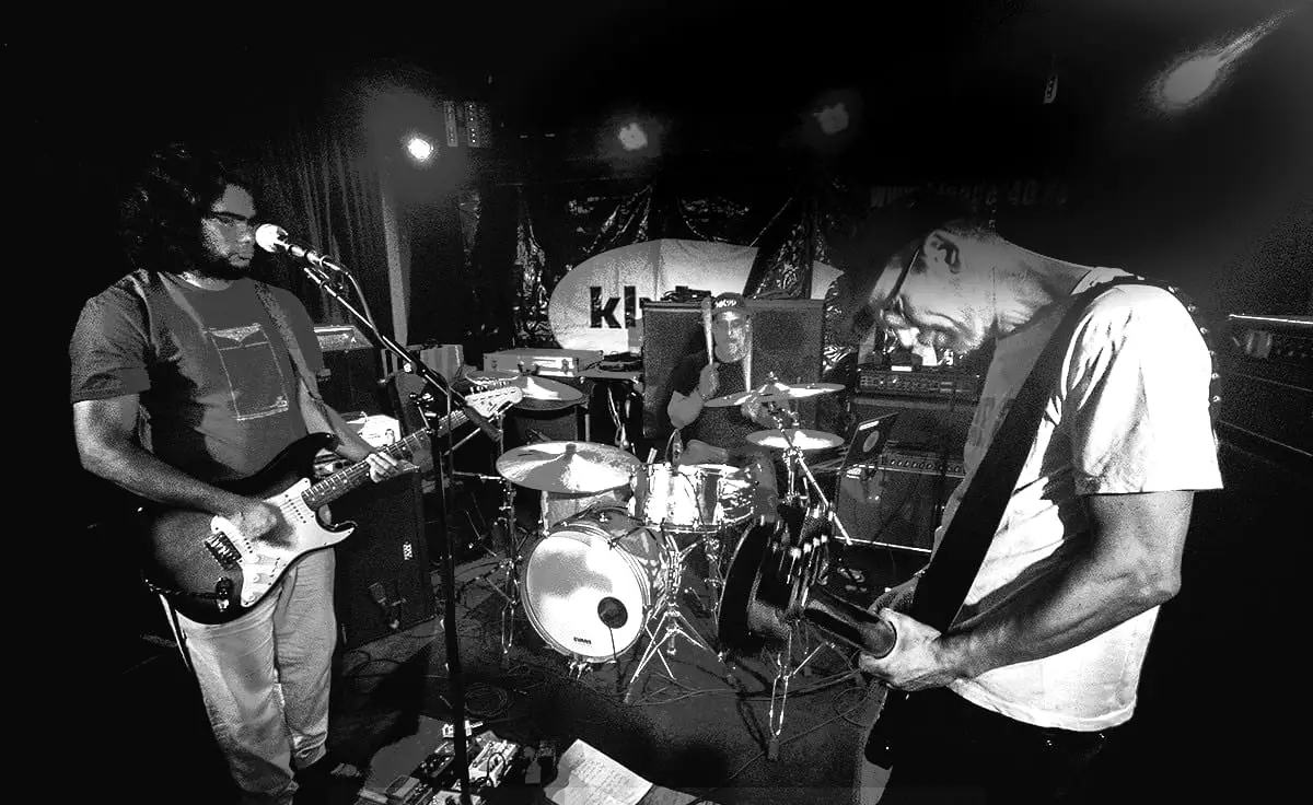 Thistles — the three band members on stage: guitar, drums and bass